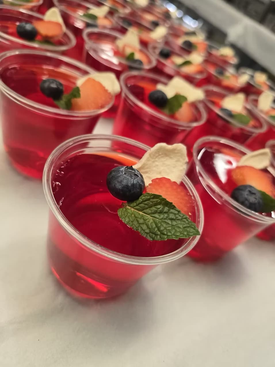 Individual dessert cups with fresh berries and mint