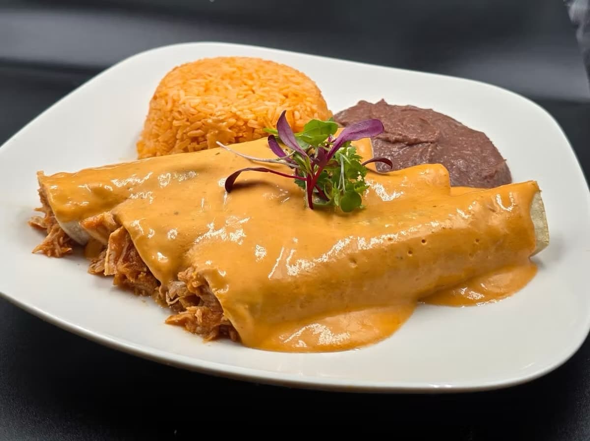 Chef-prepared enchilada dinner with rice and beans