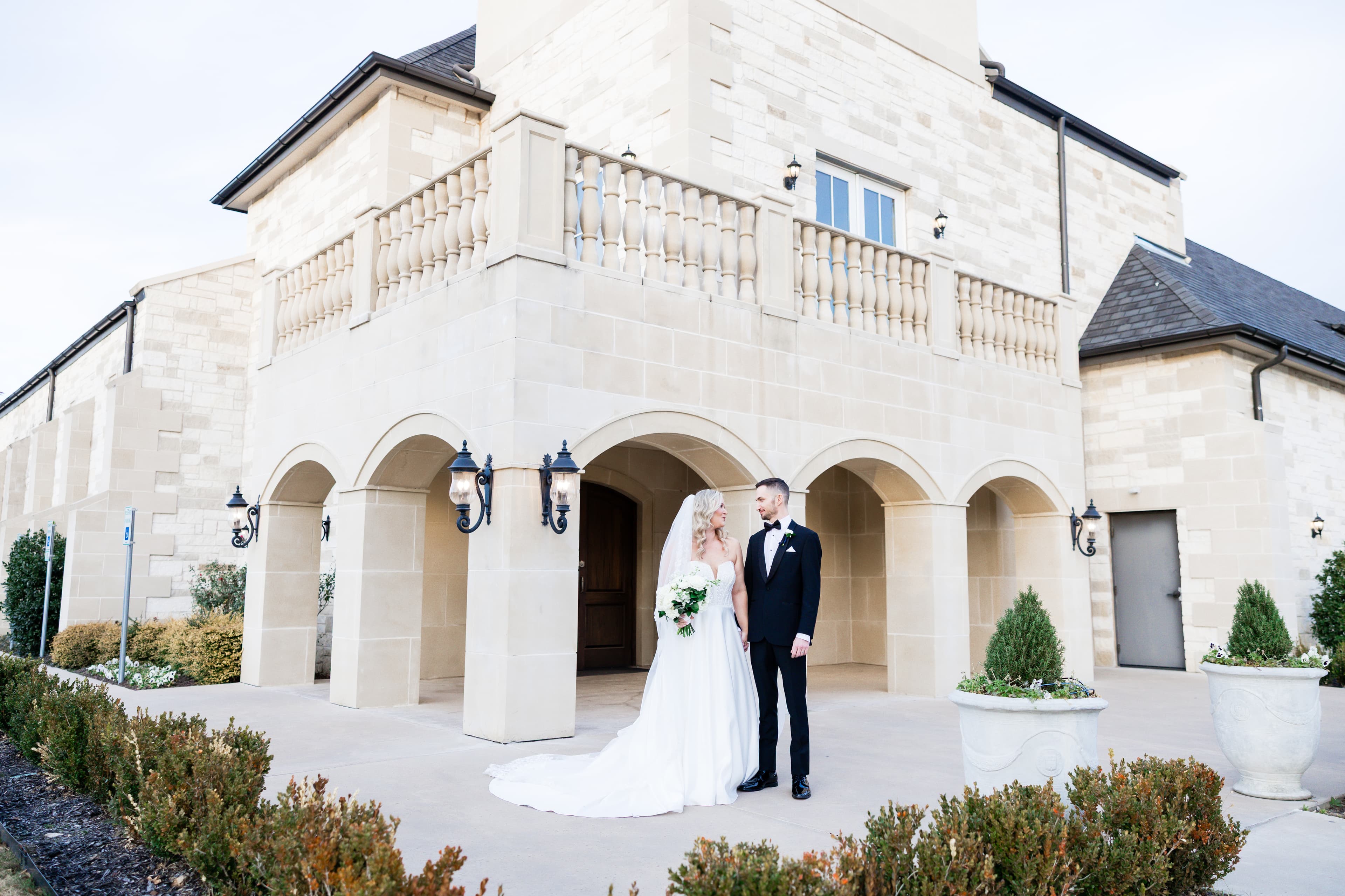 Bride and groom outside an elegant wedding venue